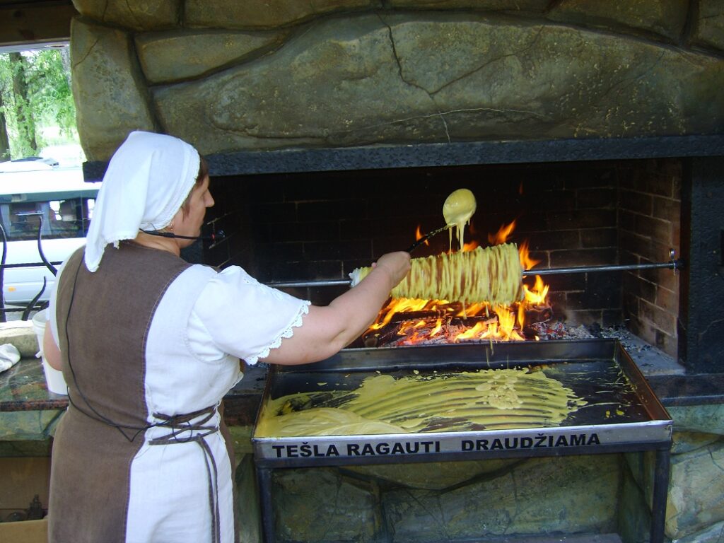 Baking Lithuanian šakotis on open fire